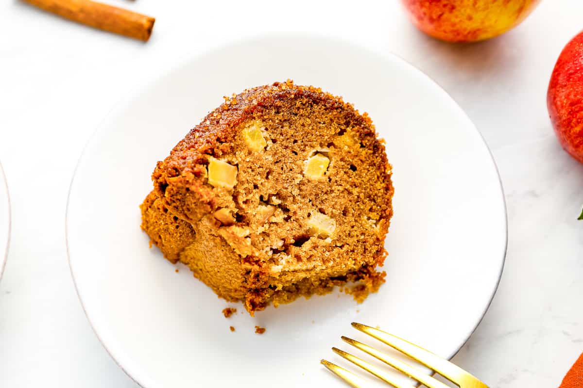 a slice of apple cinnamon bundt cake on a plate.