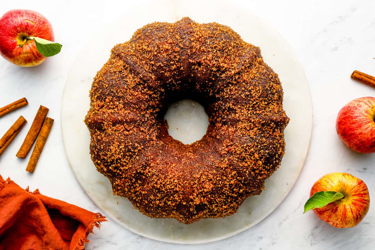 a bundt cake with cinnamon and apples on a plate.