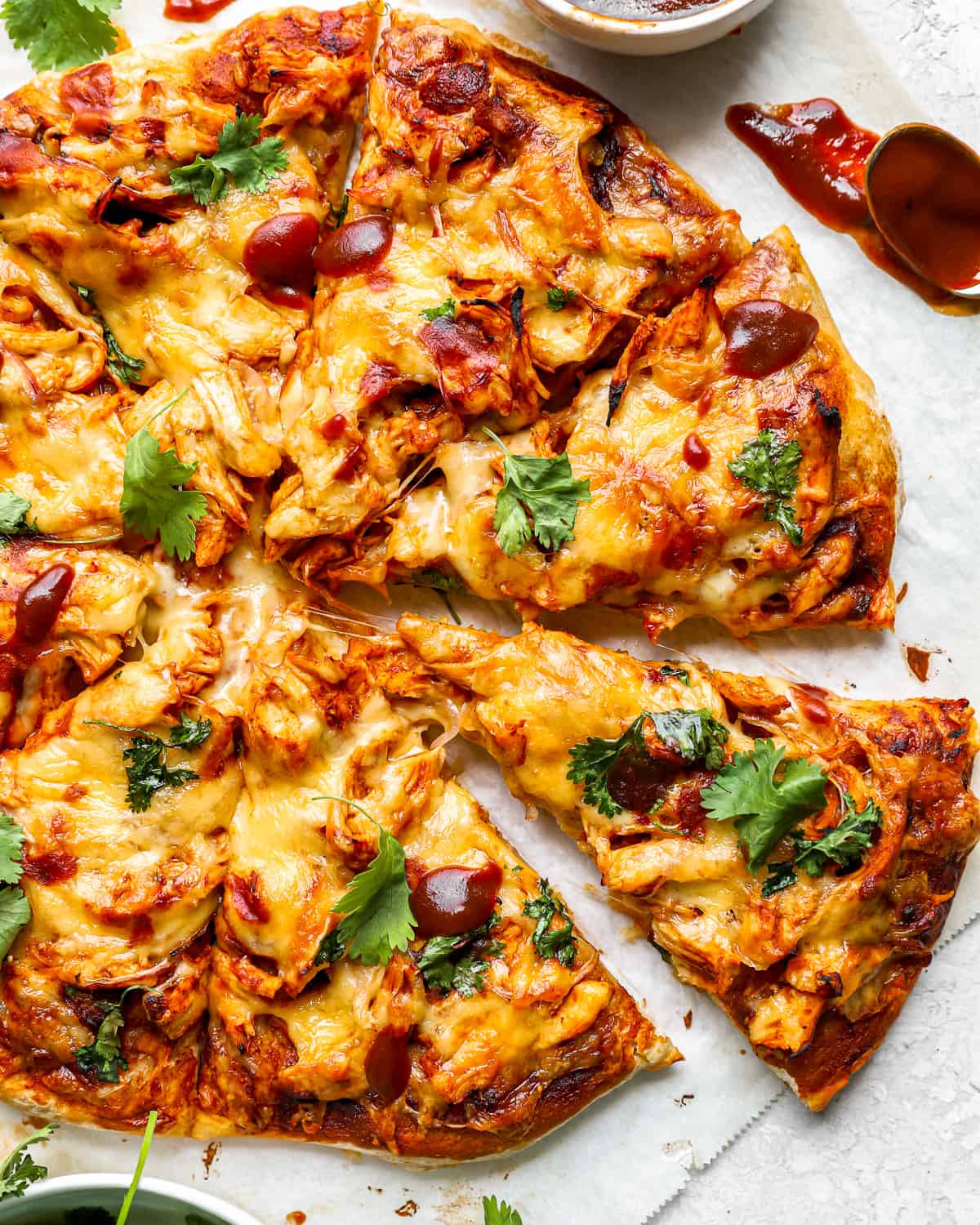 a bbq chicken pizza cut into slices.