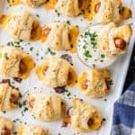 Pigs in a blanket with cheese on a baking sheet. - 12