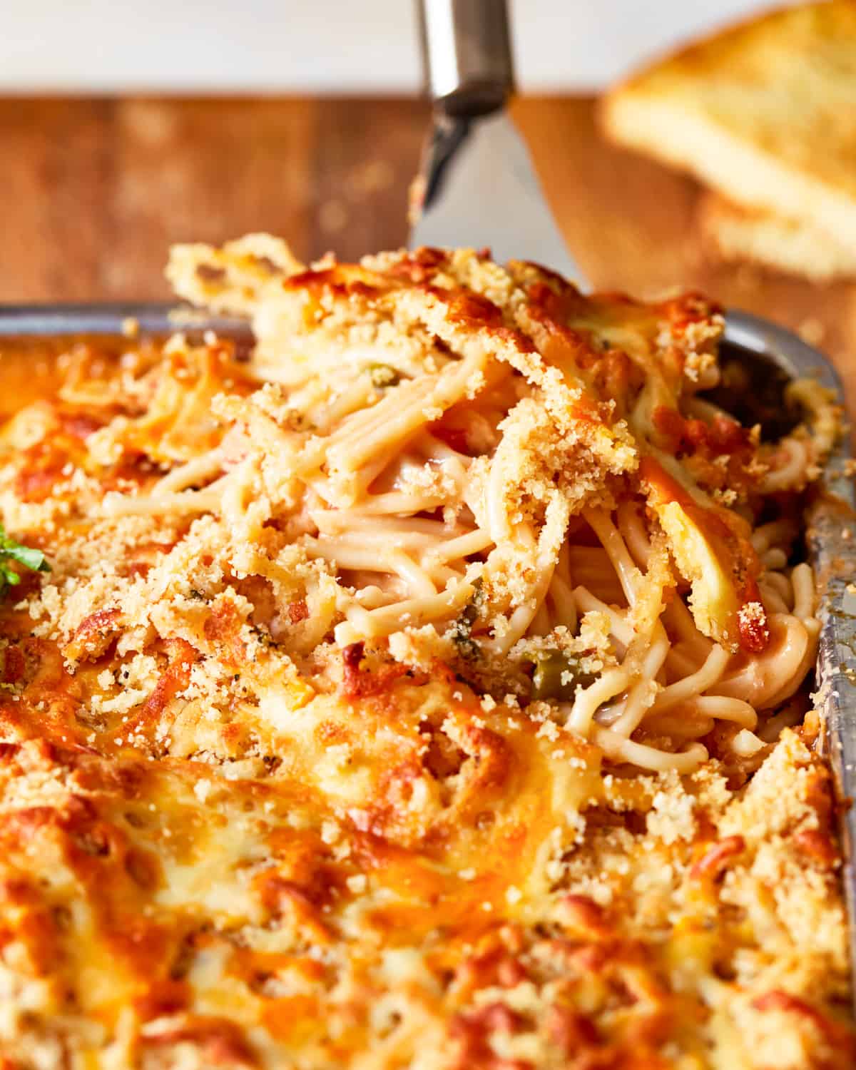 a dish of spaghetti and meatballs in a baking dish.