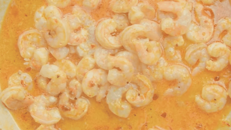 shrimp in orange-colored sauce.