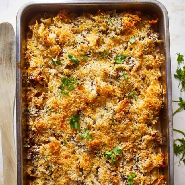 a casserole dish with cheese and parmesan on top.