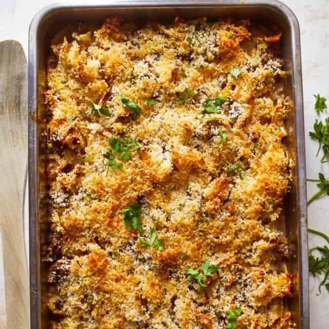 a casserole dish with cheese and parmesan on top.