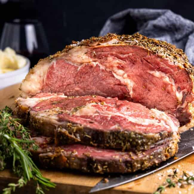 a piece of roast beef on a cutting board.