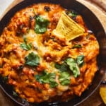 cheesy mexican dip in a skillet with tortilla chips.