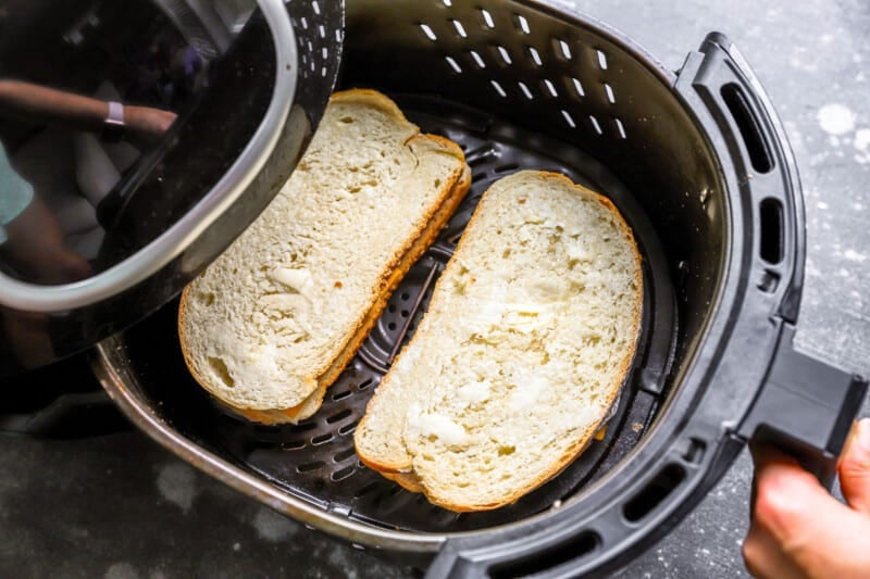 uncooked buttered grilled cheese sandwiches in the air fryer.