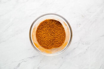 a glass bowl filled with a mixture of spices.