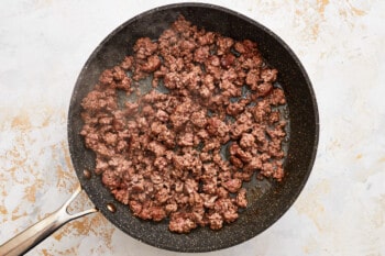 ground beef in a frying pan.