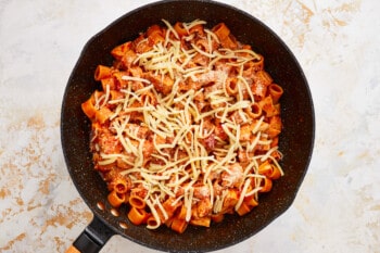 a frying pan filled with pasta and cheese.