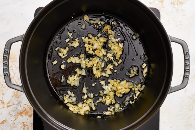 a pan with onions in it on a stove top.