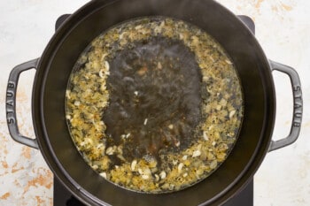 a pot full of soup on a stove top.