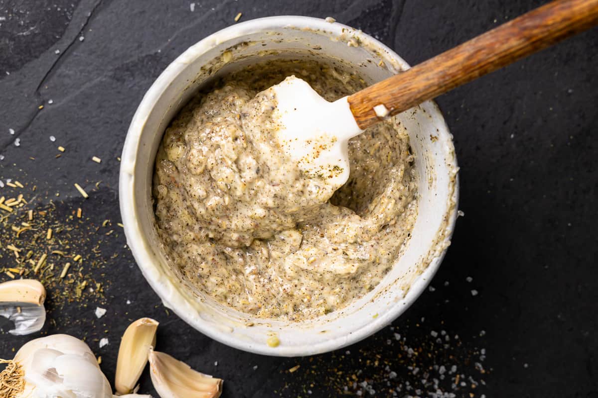 garlic paste in a bowl with a wooden spoon.