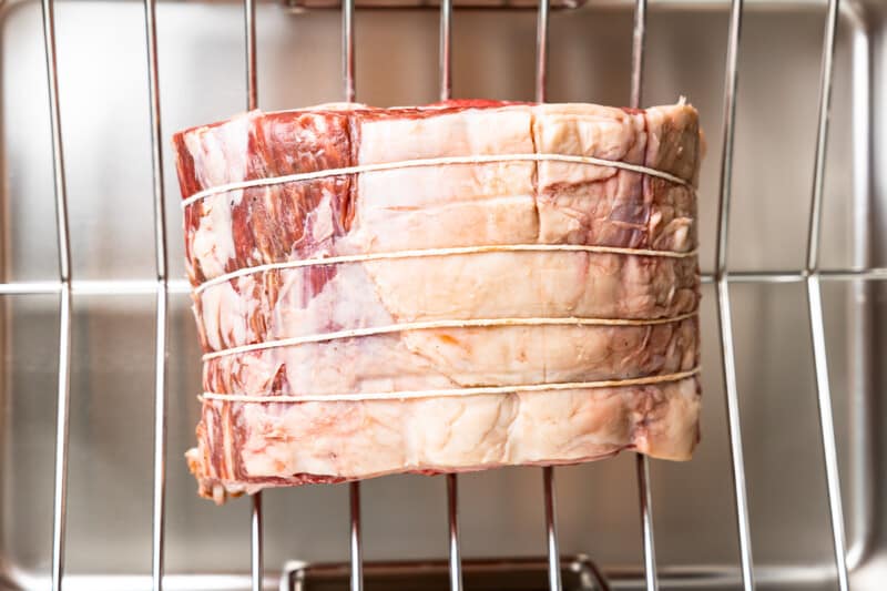a piece of meat on a wire rack in an oven.