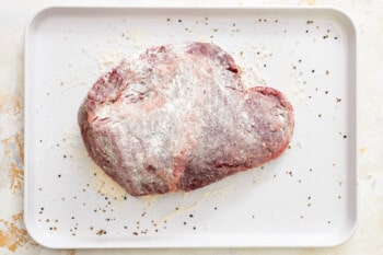 a heart shaped piece of meat on a white plate.