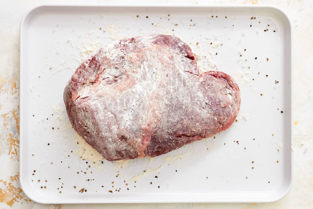 a heart shaped piece of meat on a white plate.