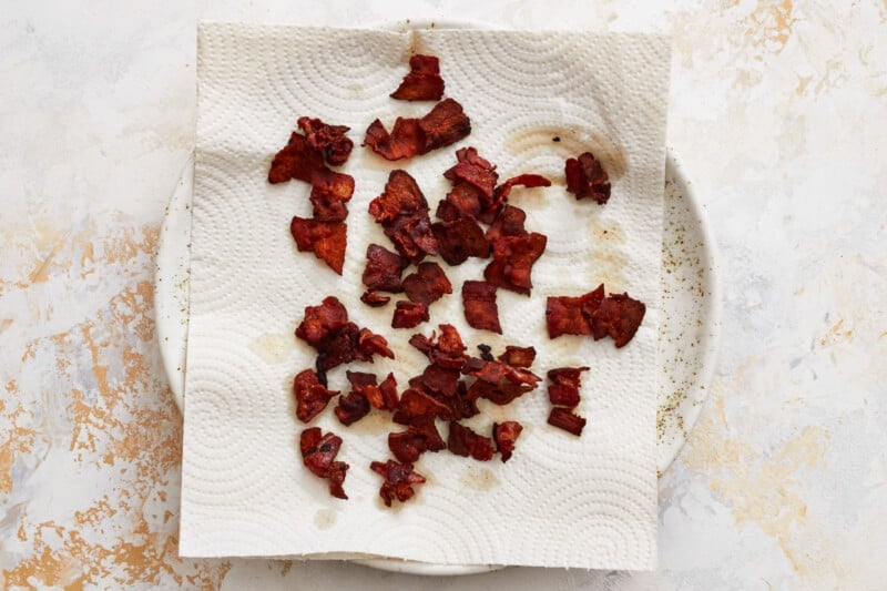 a piece of bacon on a piece of paper.