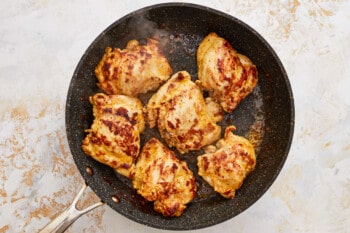 grilled chicken breasts in a frying pan.