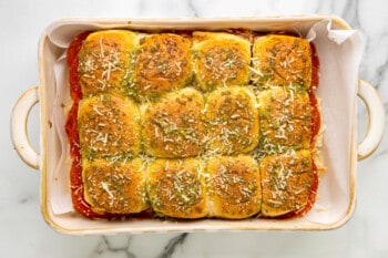 a baking dish filled with a dish of cheesy rolls.