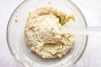 a bowl of dough with a spatula in it.