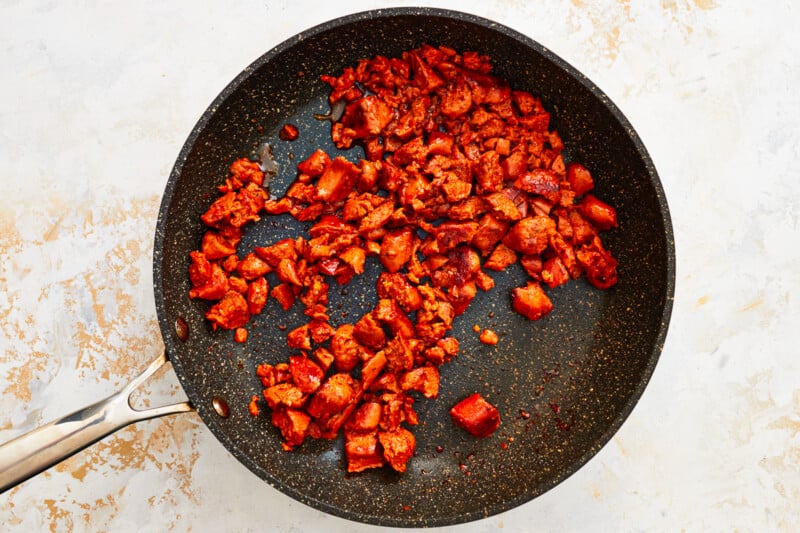 a frying pan with meat in it.