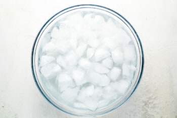 ice cubes in a glass bowl on a white background.