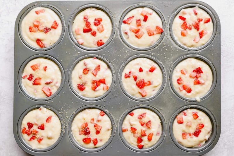strawberry muffins in a muffin tin.