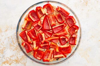 sliced red peppers in a glass baking dish.