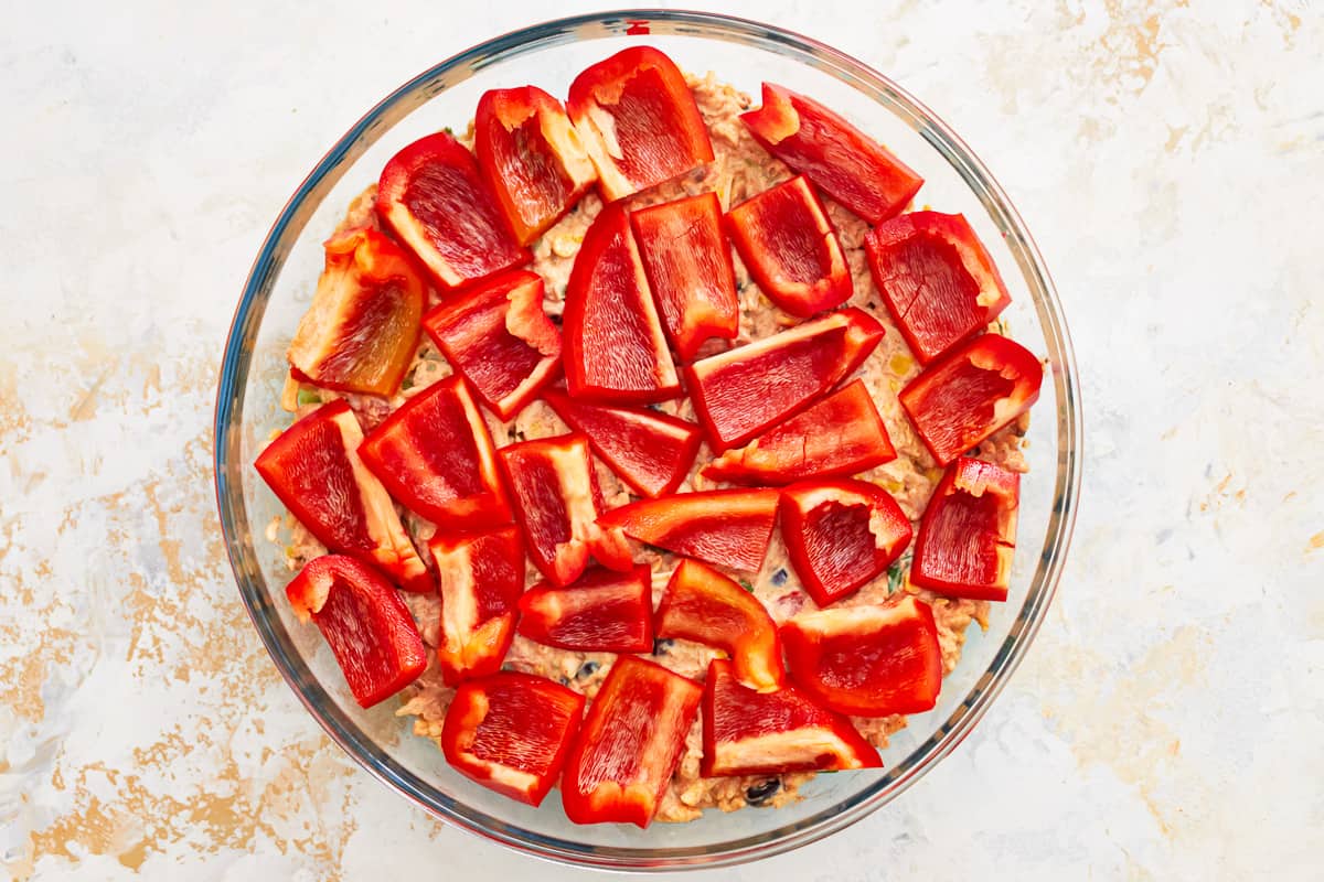 sliced red peppers in a glass baking dish.