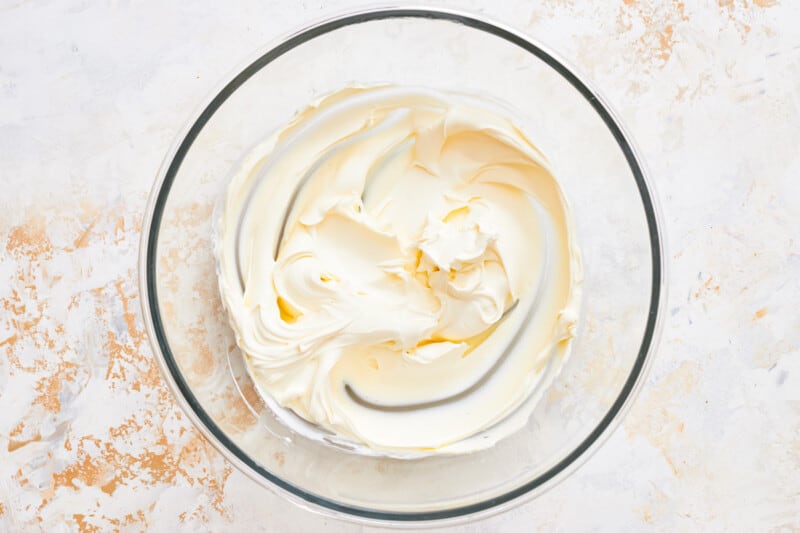 whipped cream in a glass bowl on a white background.