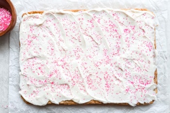 a square of white cake with pink sprinkles on top.