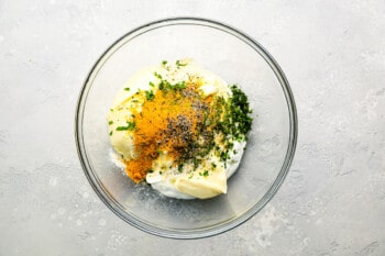 a bowl with eggs, cheese and herbs.