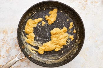 fried eggs in a frying pan with a fork.