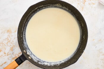 a frying pan with a white liquid in it.