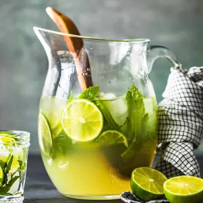 a pitcher of mojitos on a table