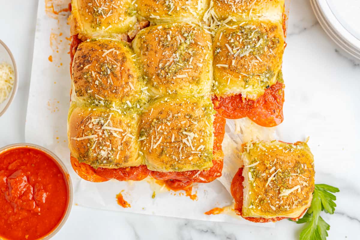 a plate of cheesy pepperoni pizza sliders.