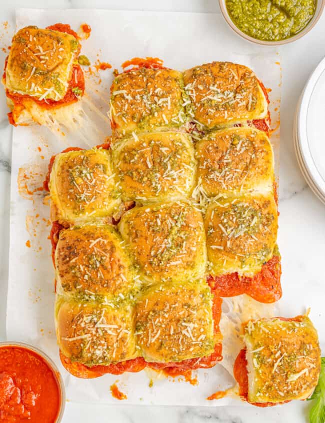 a tray of pizza sliders on a white plate.