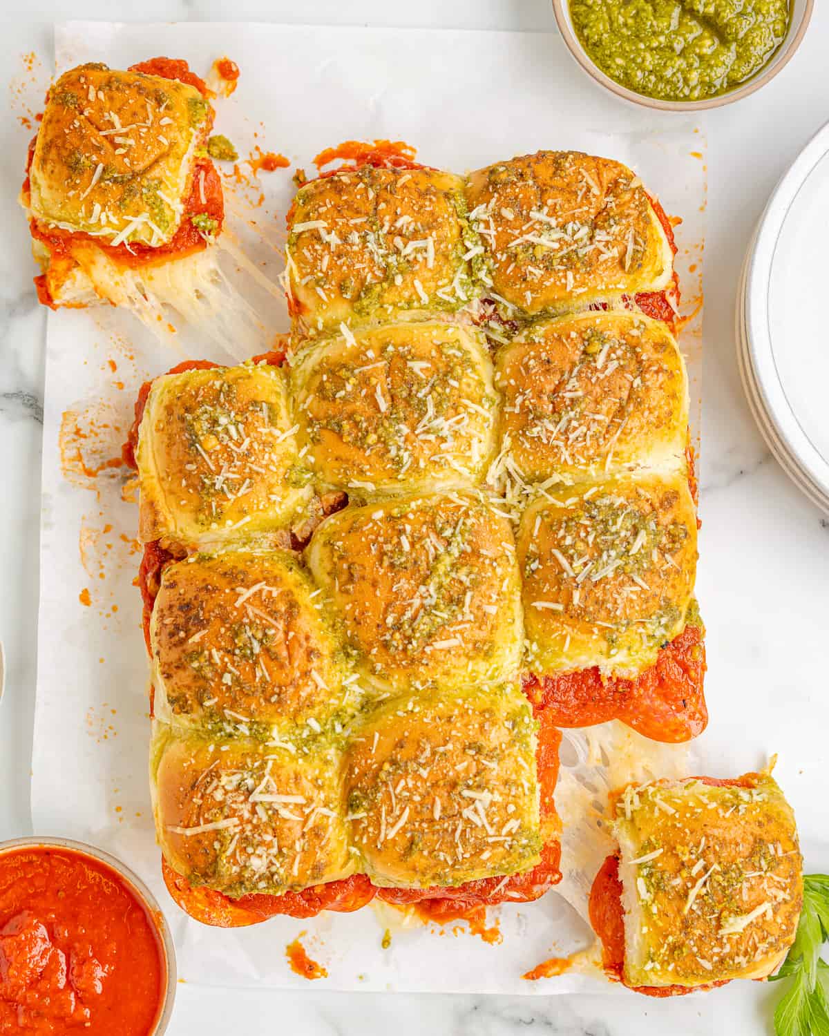 a tray of pizza sliders on a white plate.