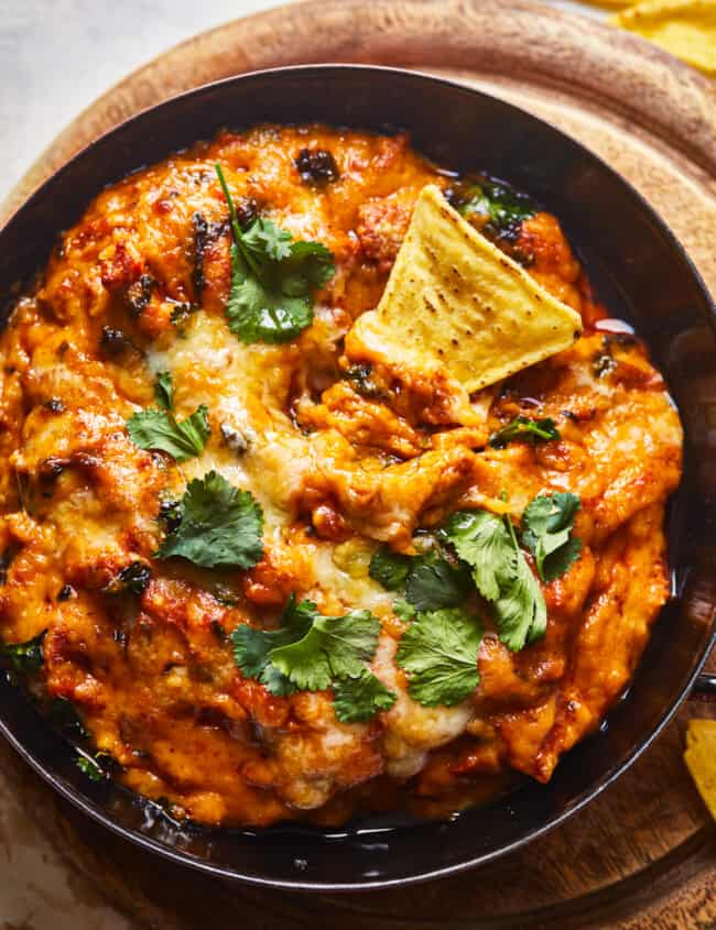 mexican cheese dip in a skillet with tortilla chips.