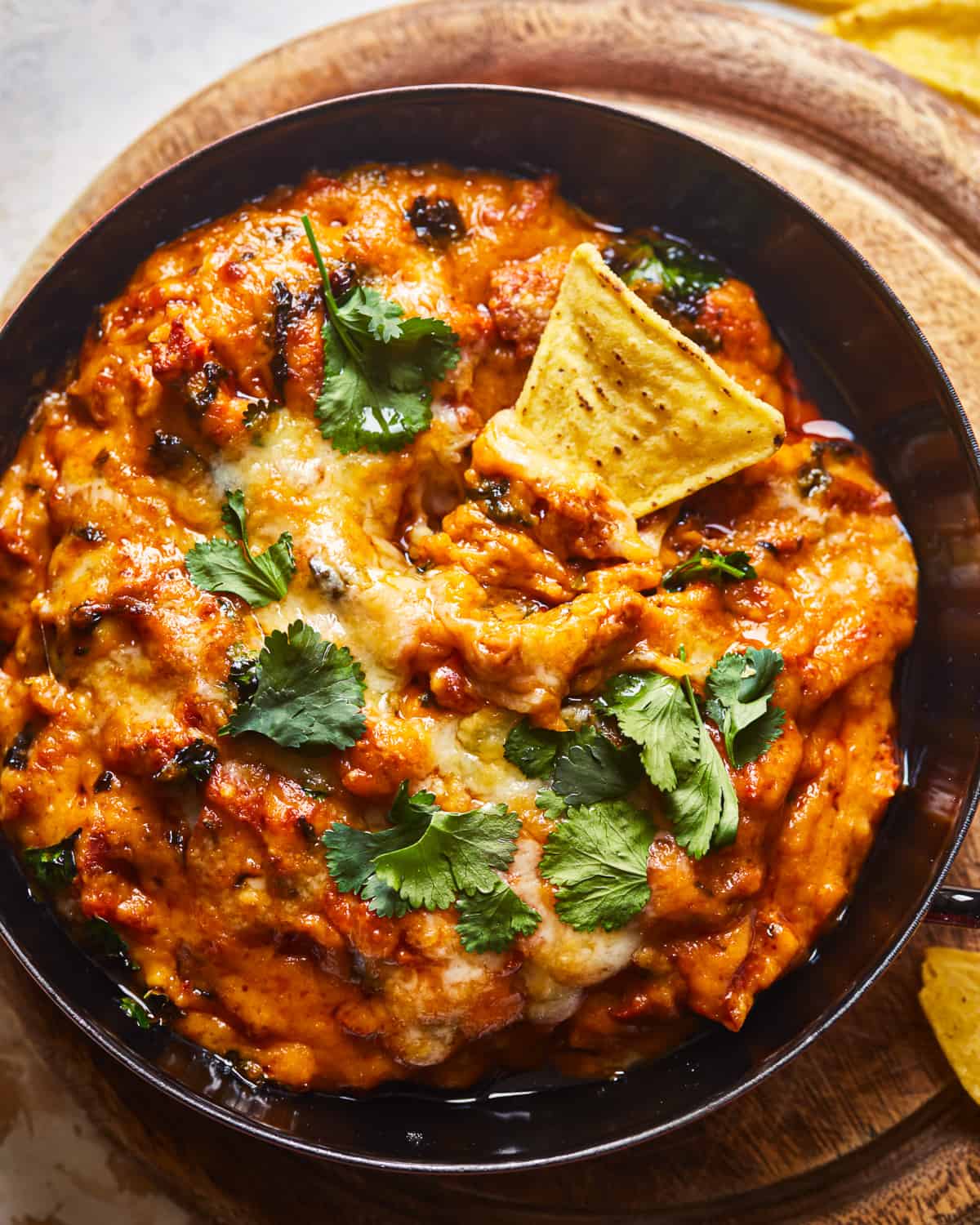 mexican cheese dip in a skillet with tortilla chips.