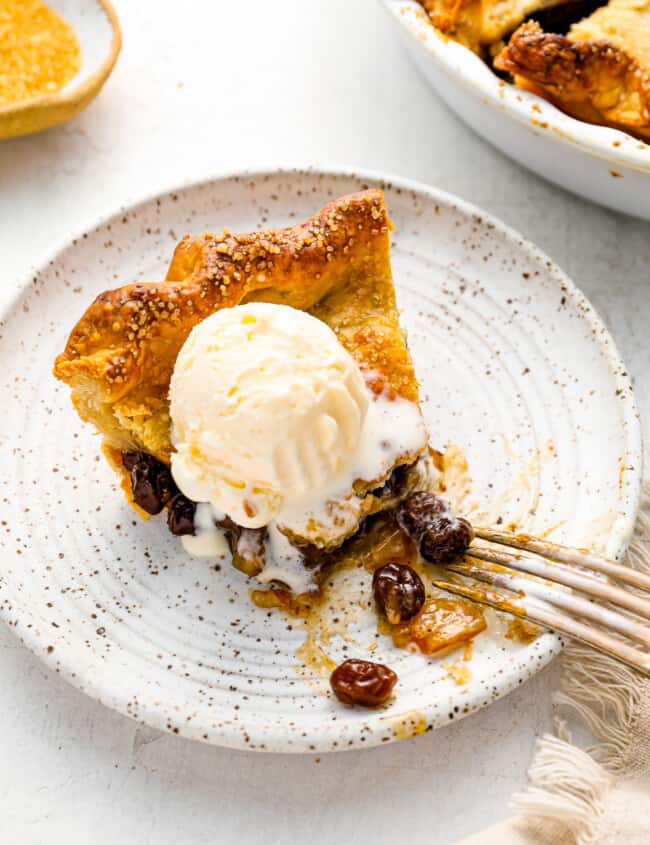 a slice of pie with ice cream on a plate.