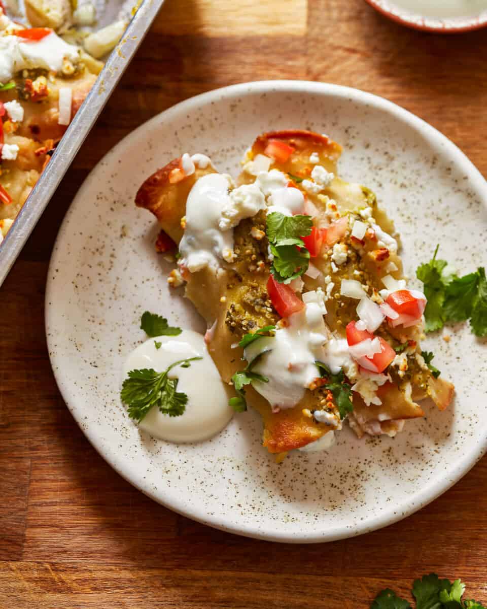 mexican enchiladas with sour cream on a plate.