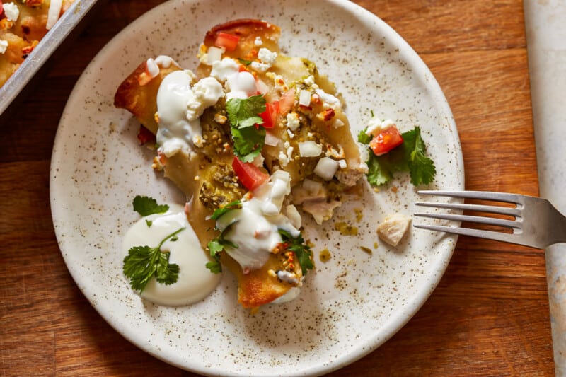 chicken enchiladas with sour cream and salsa.