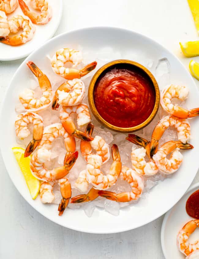 shrimp on ice with a dipping sauce.