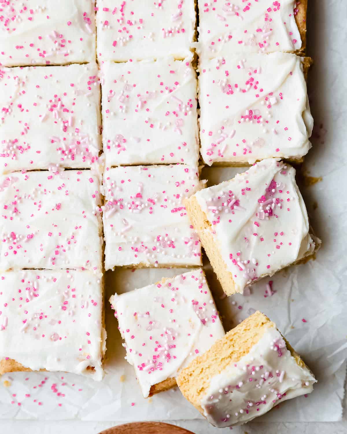 frosted sugar cookies bars cut into square slices.