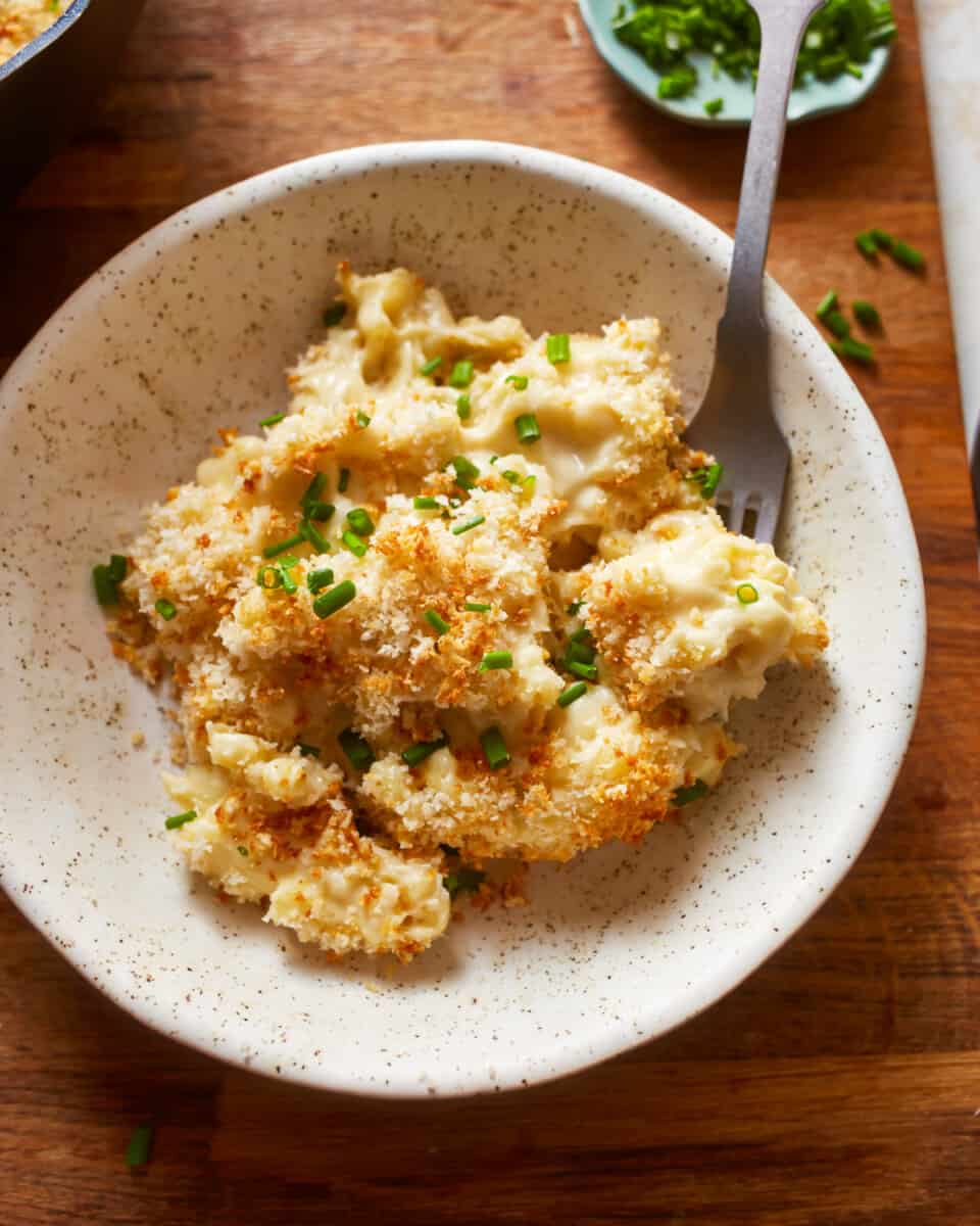 cheesy macaroni and cheese in a white bowl.