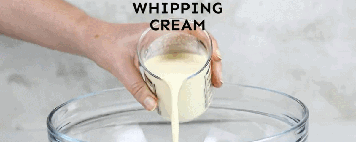 Preparing the whipped cream topping for the cake. 