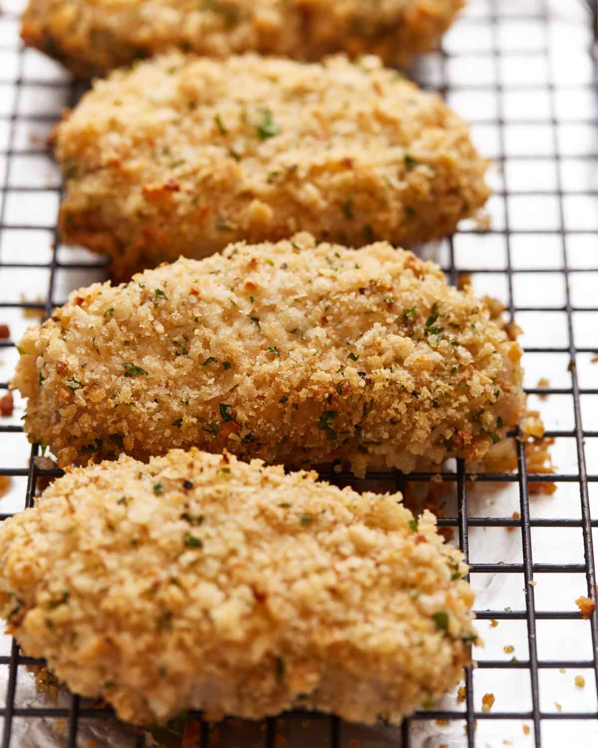 baked pork chops with breading on a cooling rack.