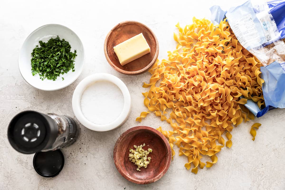 ingredients for buttered noodles spread out on a table top.