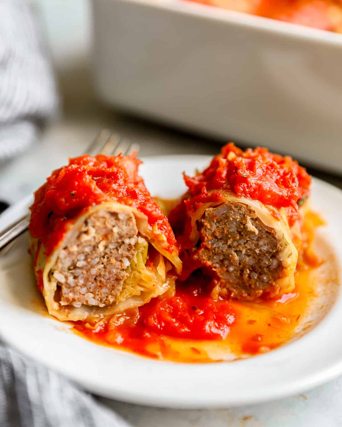 cabbage roll cut in half to reveal the meat and rice filling.